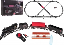 Togbane med rygende lokomotiv, lys og musik