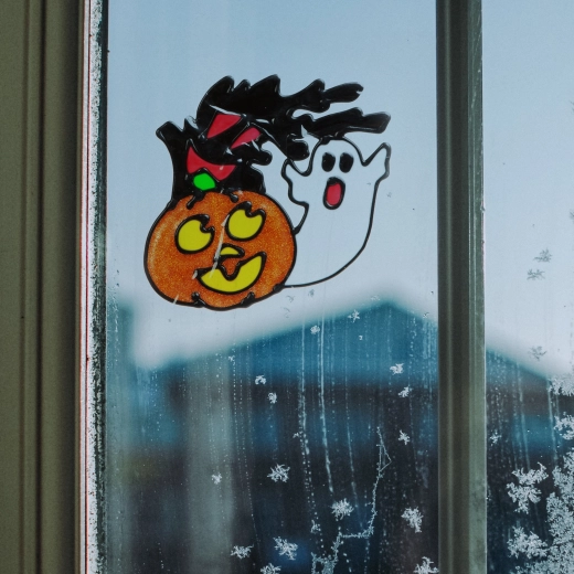 Halloween-vinduesdekoration med græskar og spøgelse