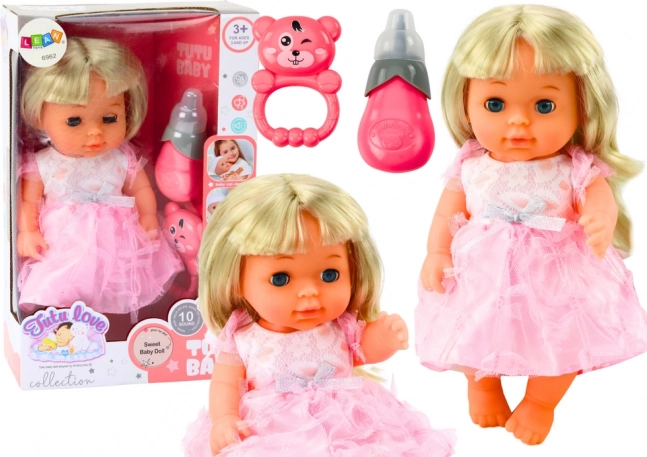 Dukke i lyserød kjole med tilbehør og lyde