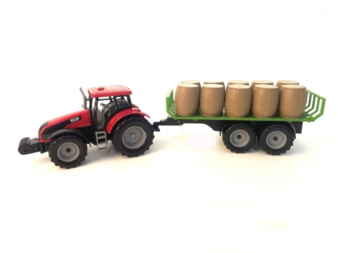 Traktor med svinghjul og trailer fyldt med hø