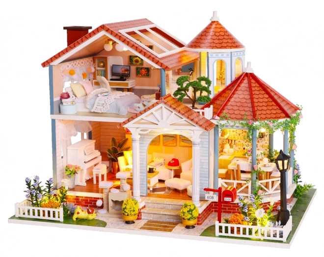 Ni miniature huse farvet glasur hus