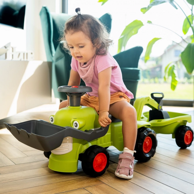 Kørende traktor Claas med trailer, læsser og skovl