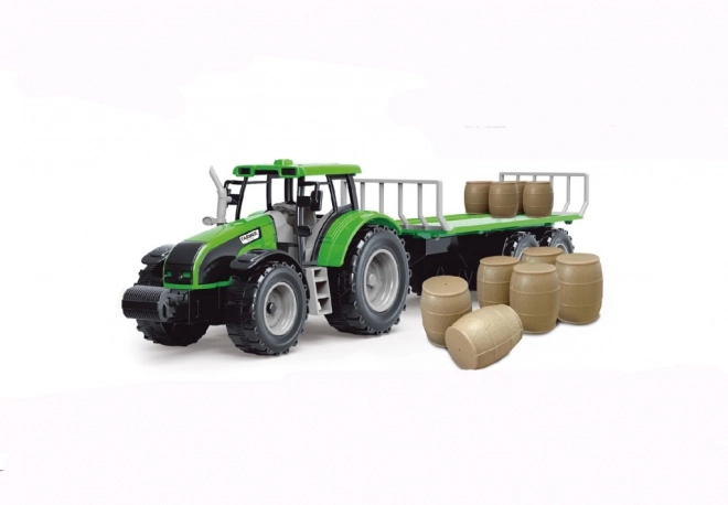 Traktor med svinghjul og trailer fyldt med hø