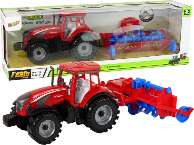 Rød traktor med plov med friktionsdrev