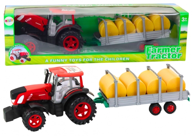 Stor traktor med trailer og høballer