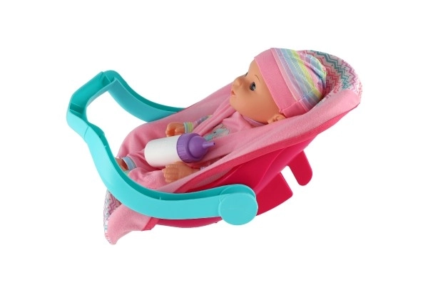 Dukke baby 30cm plast i bæreslynge/autostol med flaske i blister