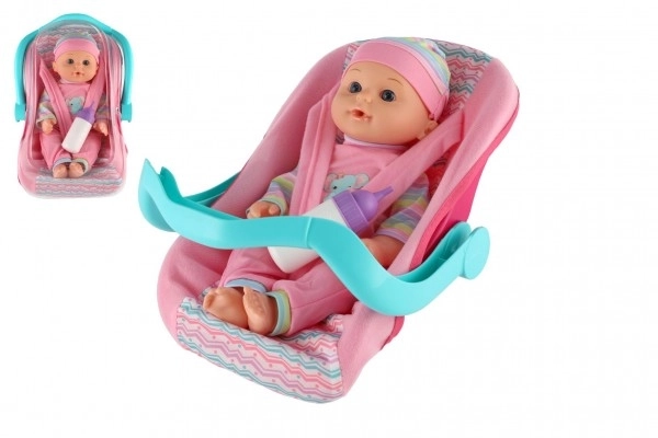 Dukke baby 30cm plast i bæreslynge/autostol med flaske i blister