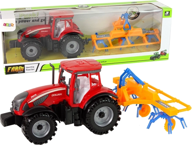 Rød traktor med rive og friktionsdrev