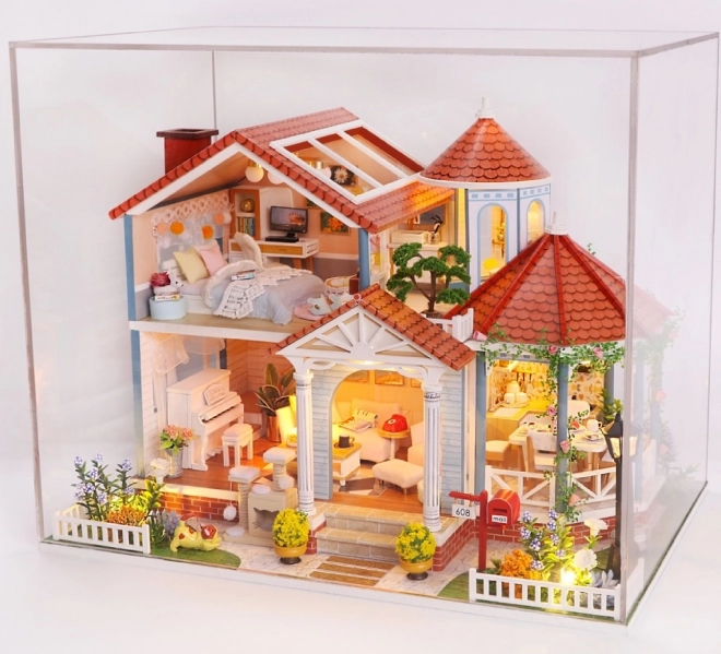 Ni miniature huse farvet glasur hus