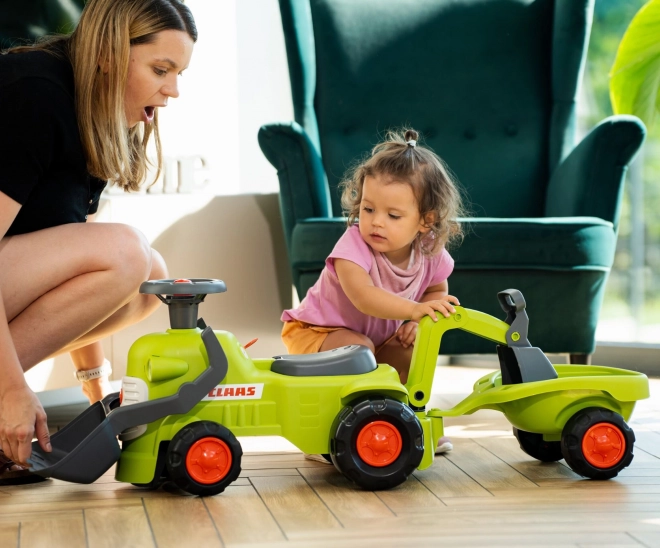 Kørende traktor Claas med trailer, læsser og skovl