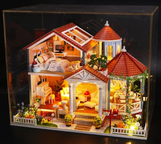 Ni miniature huse farvet glasur hus
