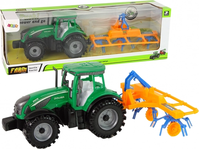 Grøn traktor med rive og friktionsdrev