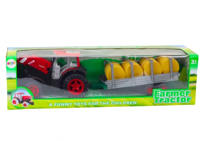 Stor traktor med trailer og høballer
