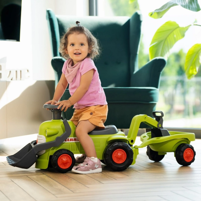 Kørende traktor Claas med trailer, læsser og skovl