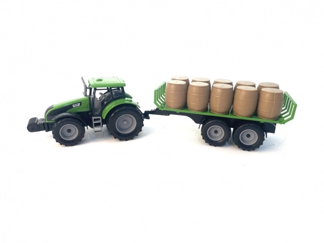 Traktor med svinghjul og trailer fyldt med hø